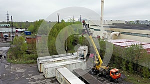 Aerial footage of a crane unloading a container from a truck