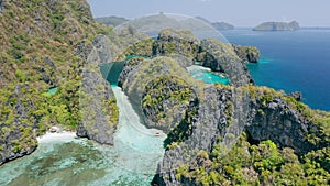 Aerial footage of entrance into big lagoon in El-Nido, Palawan. Philippines. White sand and shallow blue water unique