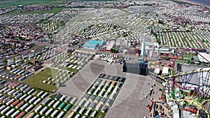 Aerial footage of the Fantasy Island caravan camping resort park in the village of Skegness showing rows of caravans and the