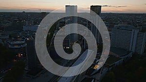 Aerial footage of Kaiser Wilhelm Memorial Church and surrounding tall modern buildings at dusk. Charlottenburg