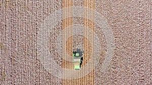 Aerial footage of a Large Cotton picker harvesting a field.