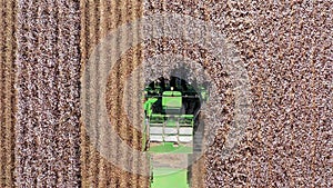 Aerial footage of a Large Cotton picker harvesting a field.