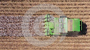 Aerial footage of a Large Cotton picker harvesting a field.