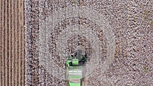 Aerial footage of a Large Cotton picker harvesting a field.