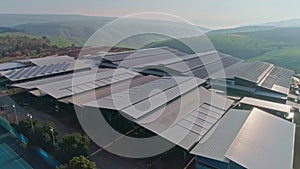 Aerial footage of large dairy farm with solar panels on the roofs