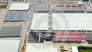 Aerial footage of a large shopping centre and car parks located in the city