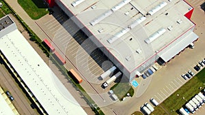 Aerial footage of a large shopping centre and car parks located in the city