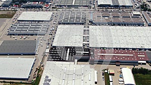 Aerial footage of a large shopping centre and car parks located in the city