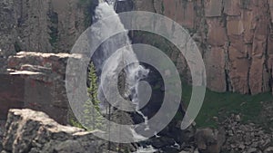Aerial footage of the North Clear Creek Falls flowing through a rocky elevation in Colorado