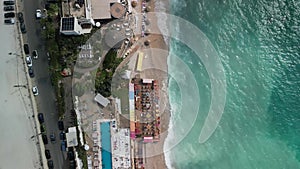 Aerial footage over Batroun coastal city houses by shiny sea in Lebanon on a summer day