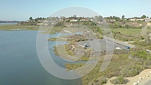 Aerial footage over the city of Newport Beach surrounded by a still pond of cordgrass