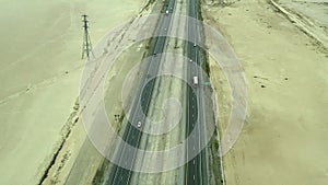 Aerial footage over trucks and cars on the fifteen freeway in the Mojave Desert