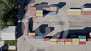 Aerial footage of port container terminal. Industrial cargo harbor. Truck