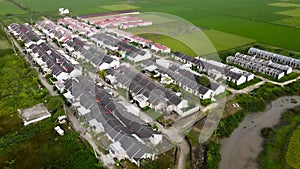 Aerial footage of showing typical suburban housing estates with rows of houses, taken on a bright sunny day