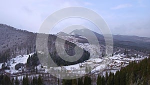 Aerial footage of small village in the mountains in winter