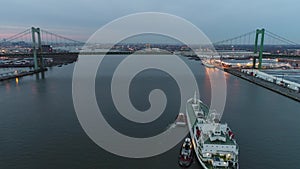 Aerial Footage of Tugboat`s Guiding a Reefer into Port