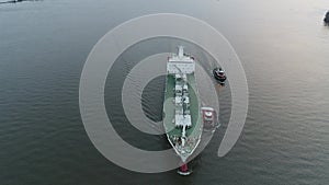 Aerial Footage of Tugboat`s Guiding a Reefer into Port