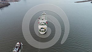 Aerial Footage of Tugboat`s Guiding a Reefer into Port