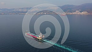 Aerial footage of ultra large empty cargo ship at sea, top down view