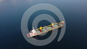 Aerial footage of ultra large empty cargo ship at sea, top down view