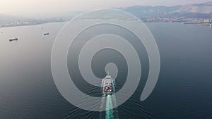 Aerial footage of ultra large empty container ship at sea, top down view