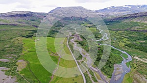 Aerial footage of a valley and old farm in rural iceland