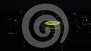 Aerial: Football stadium, Olympic stadium at night in Kiev, Ukraine. Drone footage of FC Dynamo Kyiv Stadium lighted at