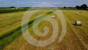 Aerial forward flying clip over field with hay bales in the English Countryside