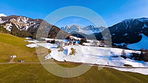 Aerial FPV drone view of spring landscape Dolomites Alps Santa Maddalena village Val di Funes valley South Tyrol Italy