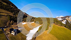 Aerial FPV drone view of spring landscape Dolomites Alps Santa Maddalena village Val di Funes valley South Tyrol Italy