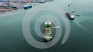 aerial front view cargo container ship carrying in sea import export goods and distributing products to dealer consumers, global