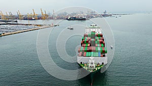 aerial front view cargo container ship carrying in sea import export goods and distributing products to dealer consumers, global