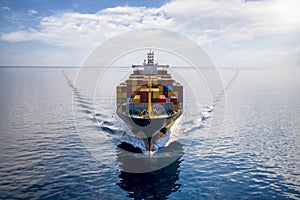 Aerial front view of a loaded container cargo vessel