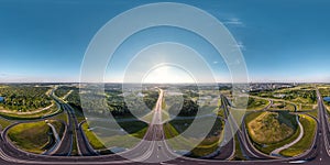 aerial full spherical seamless hdr 360 panorama over huge road junction of freeway at height of 200 meters at susnset in