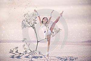 Aerial girl in a white bundle of ballerinas in airy twine and giant flowers