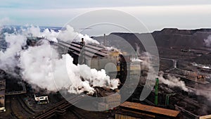 Aerial. GLOBAL WARMING. View of high chimney pipes with grey smoke. Pipes Pollute Industry Atmosphere With Smoke Ecology