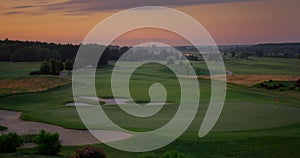 Aerial golf park sunset at cloud sky nature landscape. Golfing field background.