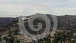 AERIAL: Griffith Observatory with flight over Hollywood Hills in Daylight, Los Angeles, California, Cloudy