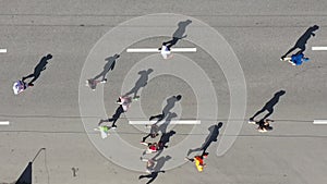 Aerial group of runners and cyclist on city road