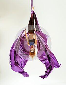 Aerial gymnast acrobat hanged on fabric