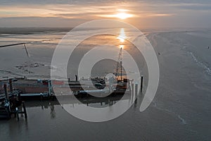 Aerial from the harbor in Holwerd with work in progress in the Netherlands at sunset