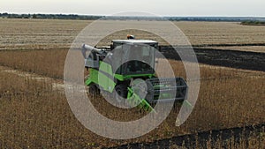 Aerial. The harvester removes soybeans. Quadrocopter. Shooting from the air
