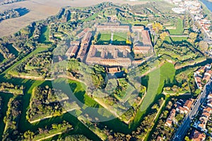 Aerial helicopter view of walls, moats, bastions, earthworks, outworks and barracks of six-star hexagon shaped renaissance fort photo