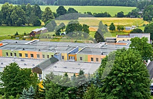 Aerial of Helios Klinik Idstein hospital with yellowing fields and trees background, Germany photo