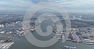 Aerial high altitude drone overview of the port of Rotterdam, Schiedam, Vlaardingen and Pernis. Nieuwe Maas river and