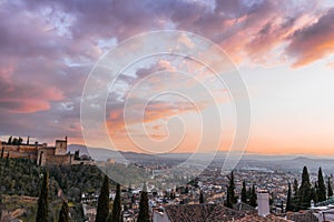 Aerial high angle shot of a cityscape under an orange sky at sunset