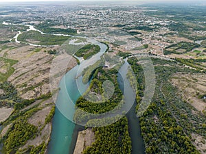 Aerial high angle view of the confluence of two rivers at the foot of a big city. Neuquen city, Patagonia Argentina