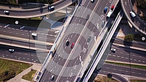 Aerial high drone flight over road traffic. Highway and overpass with cars and trucks, interchange, two-level road junction in the