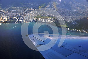 Aerial high in the sky shot of window view of plane leaving Honolulu, Hawaii