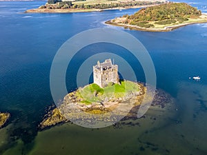 Aerial of the historic castle Stalker in Argyll in autumn, Scotland